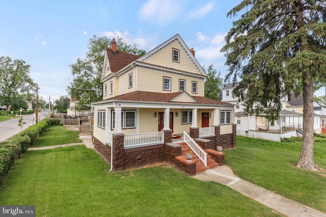 3622 Springdale Ave, Baltimore, MD 21216 - view of front of property featuring a chimney, a porch, and a front lawn