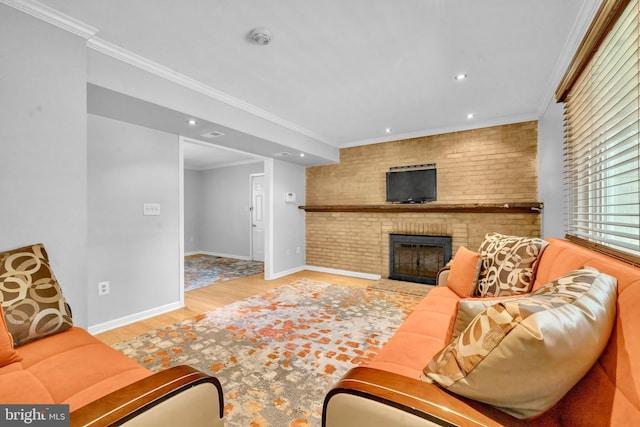 living area with a fireplace, wood finished floors, baseboards, recessed lighting, and crown molding