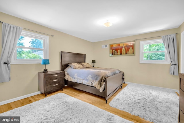 bedroom with wood finished floors and baseboards
