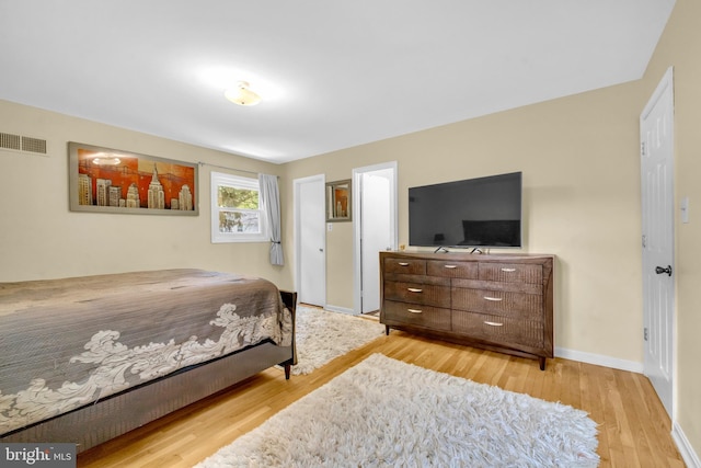 bedroom with wood finished floors and baseboards