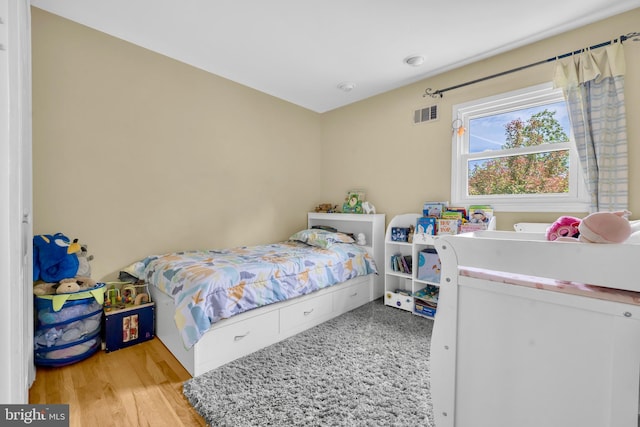 bedroom with wood finished floors