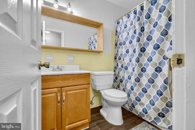 full bathroom featuring wood finished floors, tile walls, toilet, vanity, and curtained shower
