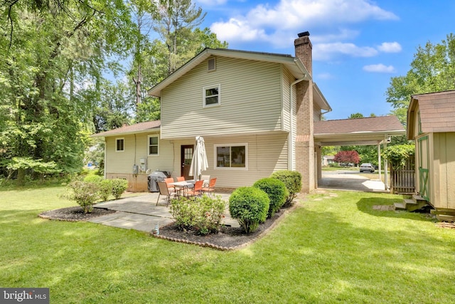 back of house with a chimney and a yard