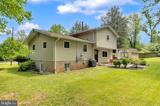 rear view of property featuring a shed, an outdoor structure, a patio, and central AC