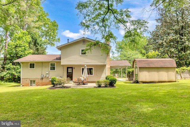 rear view of property featuring a shed, a patio area, a lawn, and an outbuilding