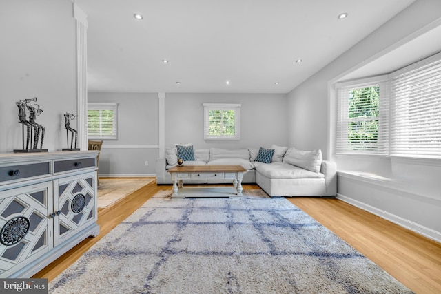 living room featuring wood finished floors, healthy amount of natural light, recessed lighting, and baseboards