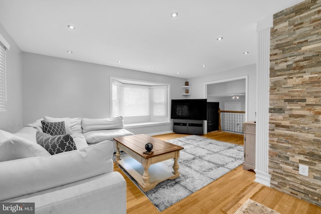 living area featuring light wood-type flooring and recessed lighting