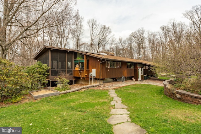 1220 Morgantown Rd, Morgantown, PA 19543 - back of house with a sunroom, a lawn, and a chimney