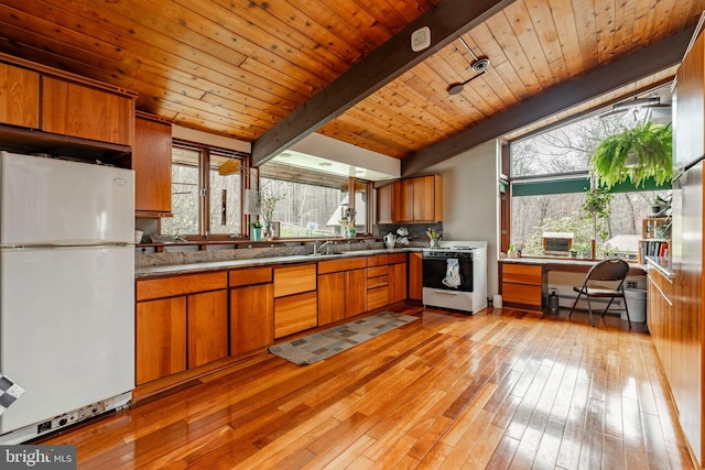 1220 Morgantown Rd, Morgantown, PA 19543 - kitchen featuring white appliances, baseboard heating, brown cabinetry, wooden ceiling, and beam ceiling