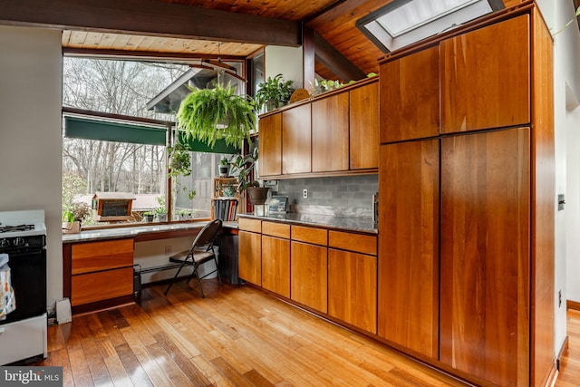 1220 Morgantown Rd, Morgantown, PA 19543 - kitchen with a skylight, range with gas stovetop, a baseboard heating unit, wood ceiling, and light wood-style flooring