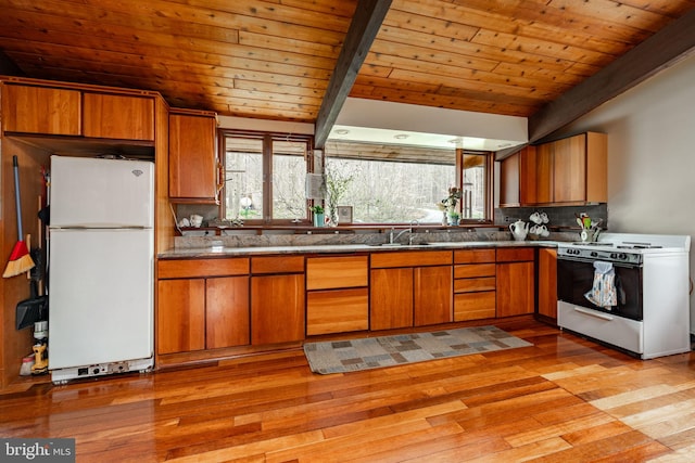 1220 Morgantown Rd, Morgantown, PA 19543 - kitchen with white appliances, wood ceiling, brown cabinetry, light wood-style floors, and backsplash