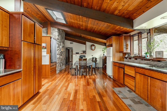 1220 Morgantown Rd, Morgantown, PA 19543 - kitchen featuring freestanding refrigerator, light wood finished floors, brown cabinets, wooden ceiling, and a skylight