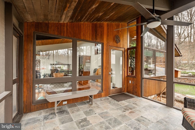 1220 Morgantown Rd, Morgantown, PA 19543 - sunroom featuring wooden walls, a ceiling fan, wood ceiling, lofted ceiling, and stone tile floors