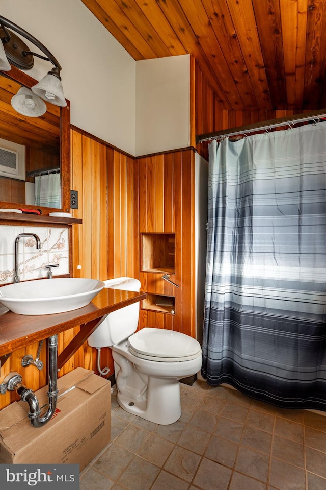 1220 Morgantown Rd, Morgantown, PA 19543 - full bathroom featuring a sink, wood ceiling, wood walls, toilet, and a shower with curtain