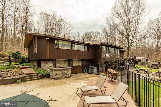 1220 Morgantown Rd, Morgantown, PA 19543 - back of property featuring a patio, stairway, fence, and stone siding