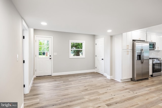 1985 W Blvd, Malaga, NJ 08328 - kitchen with appliances with stainless steel finishes, light wood finished floors, white cabinets, backsplash, and baseboards