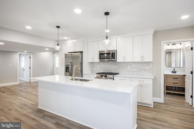 1985 W Blvd, Malaga, NJ 08328 - kitchen featuring appliances with stainless steel finishes, a sink, white cabinetry, tasteful backsplash, and light wood-type flooring