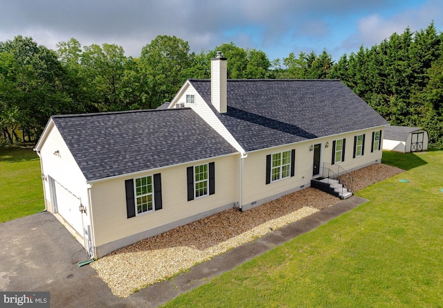 single story home with a chimney, roof with shingles, driveway, and a storage unit