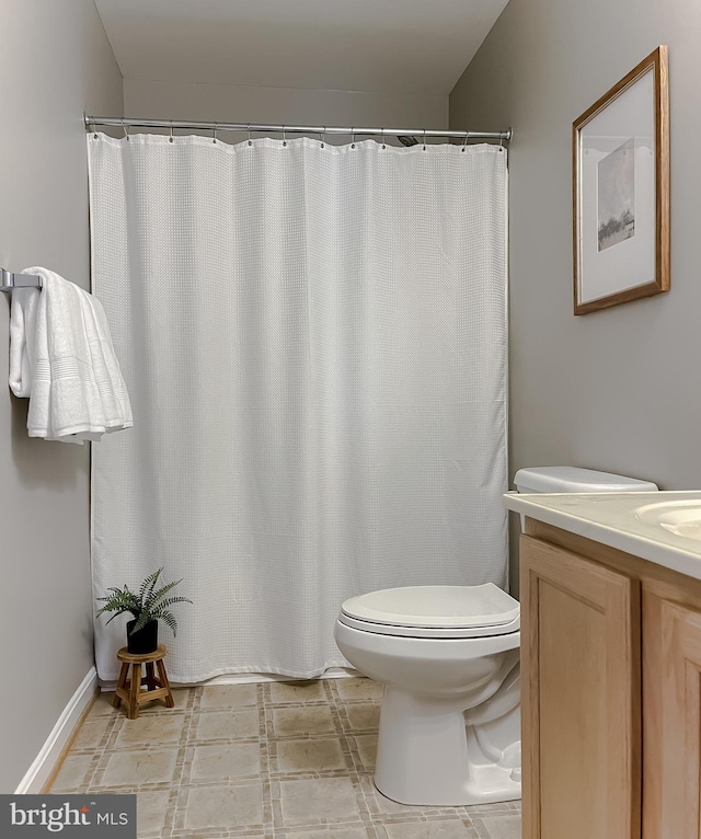 full bathroom with toilet and vanity