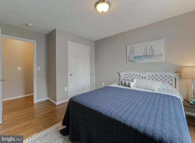 bedroom with wood finished floors and baseboards