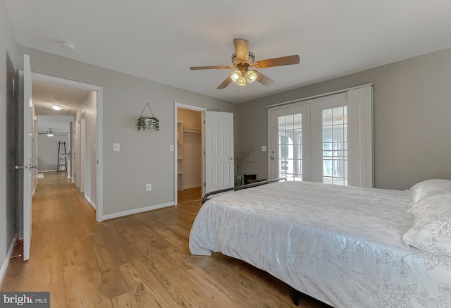 bedroom with light wood-type flooring, baseboards, access to exterior, and a ceiling fan