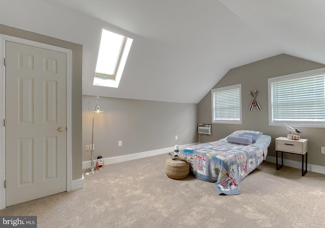 bedroom featuring carpet floors, vaulted ceiling, a skylight, an AC wall unit, and baseboards