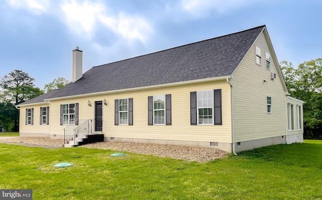 rear view of house featuring crawl space, a chimney, and a lawn