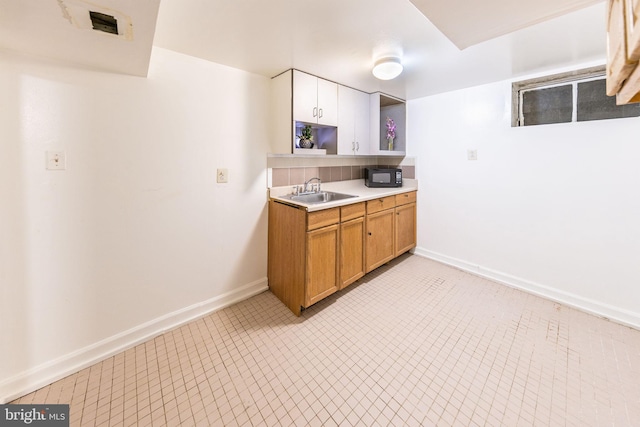 3321 Clay St, Silver Spring, MD 20902 - kitchen with black microwave, a sink, open shelves, light countertops, and baseboards