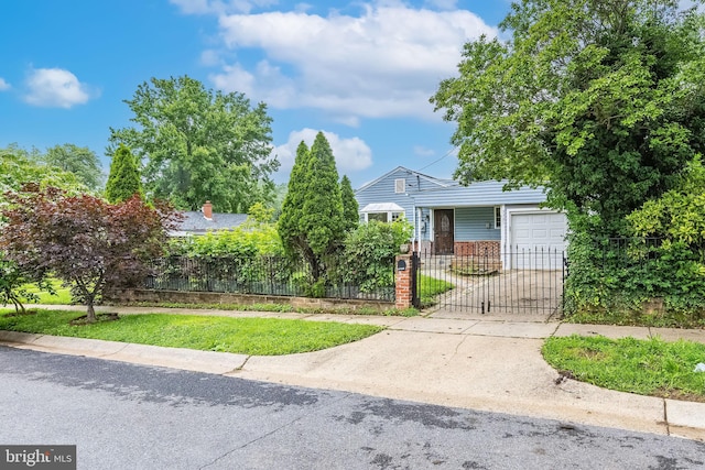 3321 Clay St, Silver Spring, MD 20902 - obstructed view of property featuring an attached garage, a fenced front yard, driveway, brick siding, and a gate