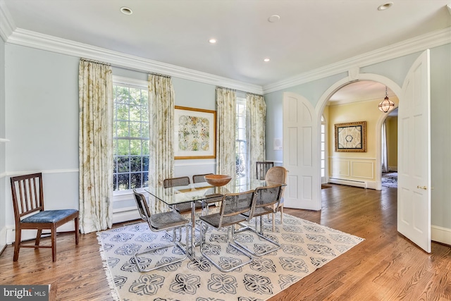 6437 Blantyre, Warrenton, VA 20187 - dining space with arched walkways, crown molding, a baseboard heating unit, wood finished floors, and a wainscoted wall