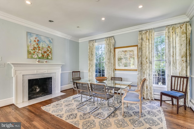 6437 Blantyre, Warrenton, VA 20187 - dining space featuring ornamental molding, wood finished floors, a fireplace, baseboards, and recessed lighting