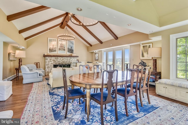 6437 Blantyre, Warrenton, VA 20187 - dining area with a chandelier, wood finished floors, beamed ceiling, a fireplace, and a baseboard radiator