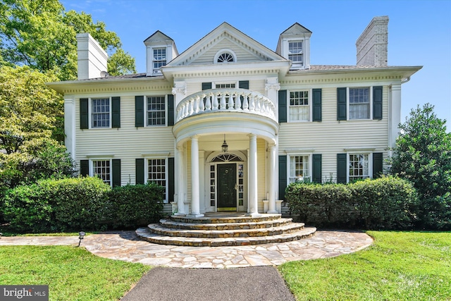 6437 Blantyre, Warrenton, VA 20187 - view of front of property featuring a chimney, a balcony, and a front lawn