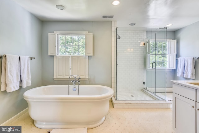 6437 Blantyre, Warrenton, VA 20187 - full bath featuring a shower stall, a baseboard radiator, a freestanding tub, plenty of natural light, and recessed lighting
