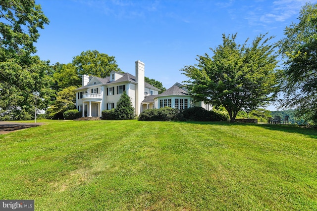 6437 Blantyre, Warrenton, VA 20187 - view of front of property with a chimney, a front yard, and a balcony