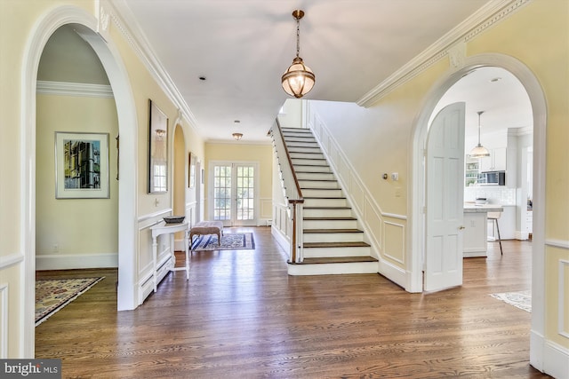 6437 Blantyre, Warrenton, VA 20187 - foyer featuring dark wood finished floors, stairway, ornamental molding, and arched walkways