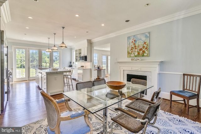 6437 Blantyre, Warrenton, VA 20187 - dining area with healthy amount of natural light, a fireplace, wood finished floors, crown molding, and recessed lighting