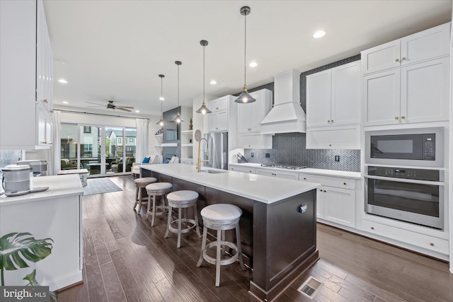 20383 Codman Dr, Ashburn, VA 20147 - kitchen featuring stainless steel appliances, custom exhaust hood, white cabinetry, a sink, and ceiling fan