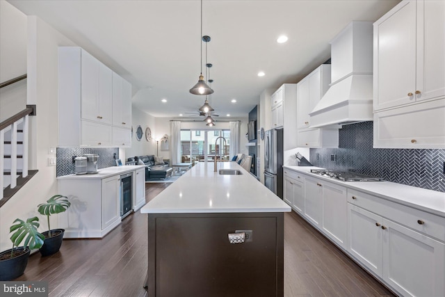20383 Codman Dr, Ashburn, VA 20147 - kitchen featuring open floor plan, a sink, stainless steel appliances, beverage cooler, and dark wood-style floors