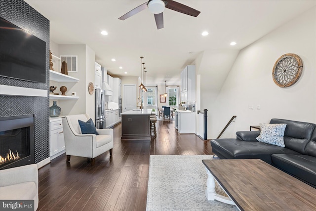 20383 Codman Dr, Ashburn, VA 20147 - living room with dark wood-style flooring, a tile fireplace, a ceiling fan, and recessed lighting