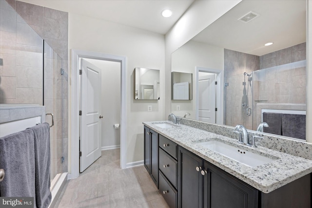 20383 Codman Dr, Ashburn, VA 20147 - bathroom with double vanity, a shower stall, baseboards, and tile patterned flooring