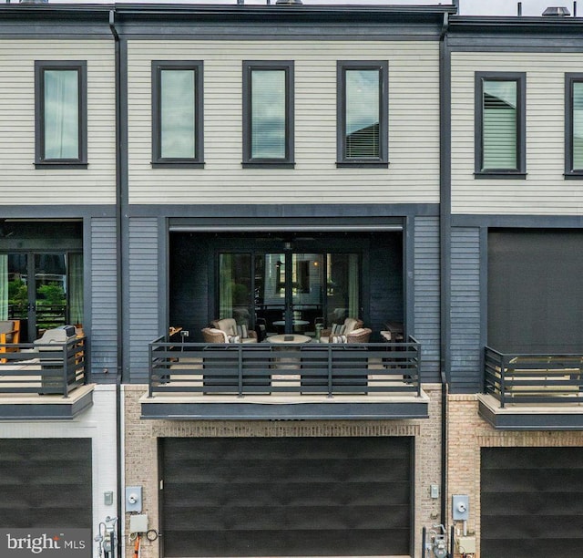 20383 Codman Dr, Ashburn, VA 20147 - rear view of house featuring an attached garage and a balcony
