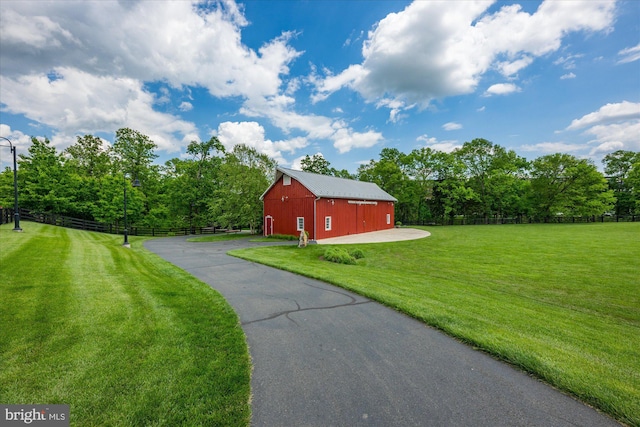 20383 Codman Dr, Ashburn, VA 20147 - view of yard with a barn, an outbuilding, driveway, and view of wooded area