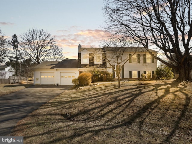 2 Darnell Ct, Olney, MD 20832 - view of front of home with asphalt driveway, a garage, a chimney, and a lawn