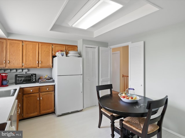 2 Darnell Ct, Olney, MD 20832 - kitchen with freestanding refrigerator, brown cabinets, light countertops, and a sink