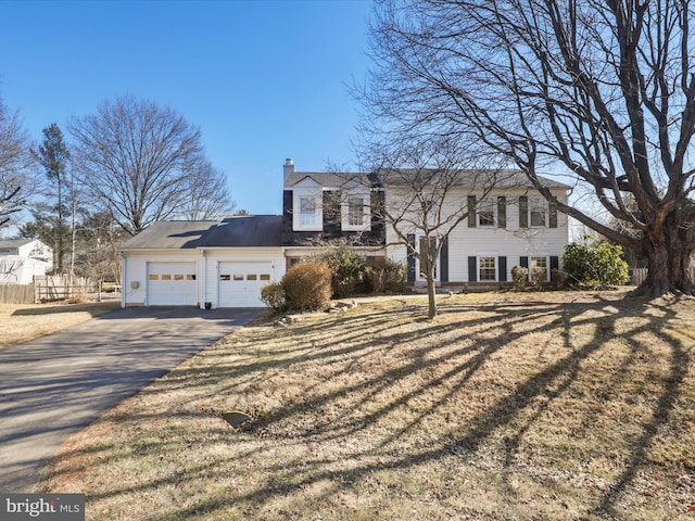 2 Darnell Ct, Olney, MD 20832 - view of front facade featuring asphalt driveway, a garage, and a chimney