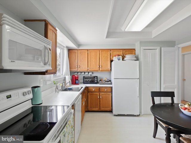2 Darnell Ct, Olney, MD 20832 - kitchen featuring white appliances, a sink, light countertops, brown cabinetry, and light floors