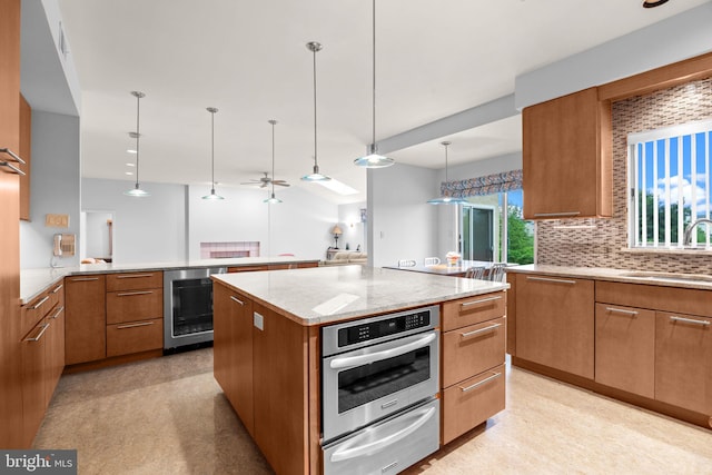 11 Candace Ct, Richboro, PA 18954 - kitchen with beverage cooler, a warming drawer, oven, a sink, and light stone counters