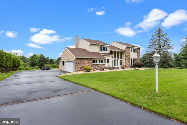 11 Candace Ct, Richboro, PA 18954 - view of front of home with stone siding, asphalt driveway, a chimney, a front lawn, and a garage