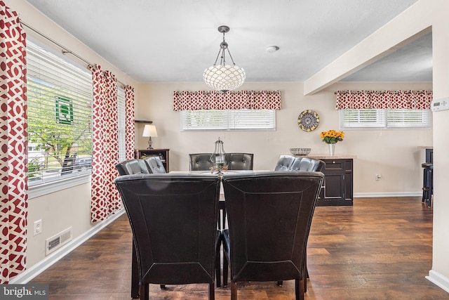 dining room with baseboards, dark wood-style flooring, healthy amount of natural light, and beam ceiling